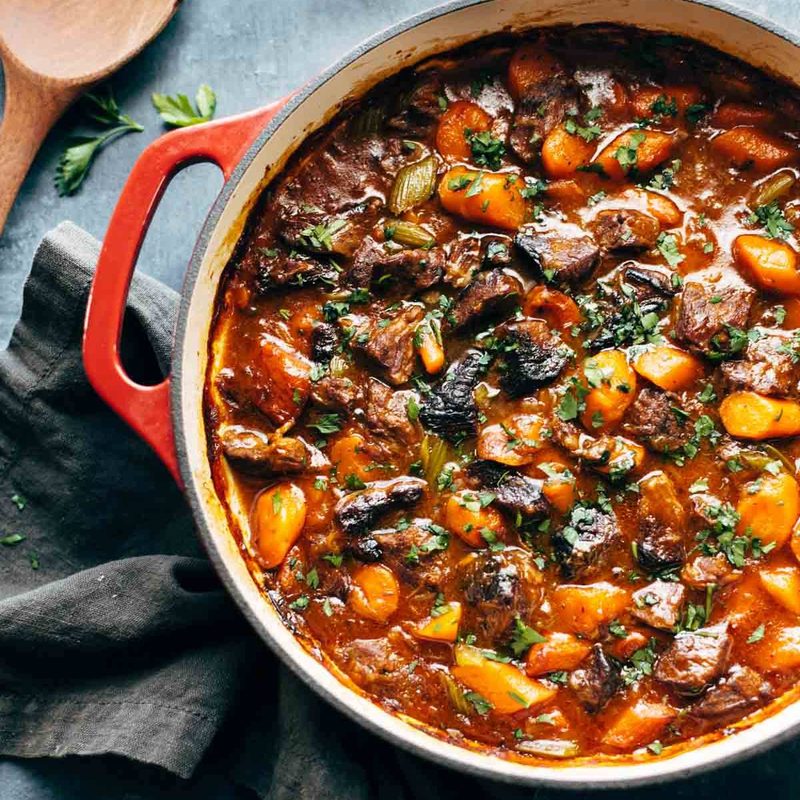 A pot of stew on a blue tablecloth.