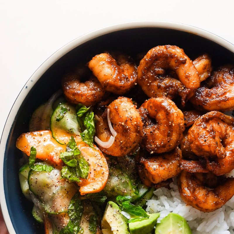 Spicy shrimp in a bowl with rice and peach salad.