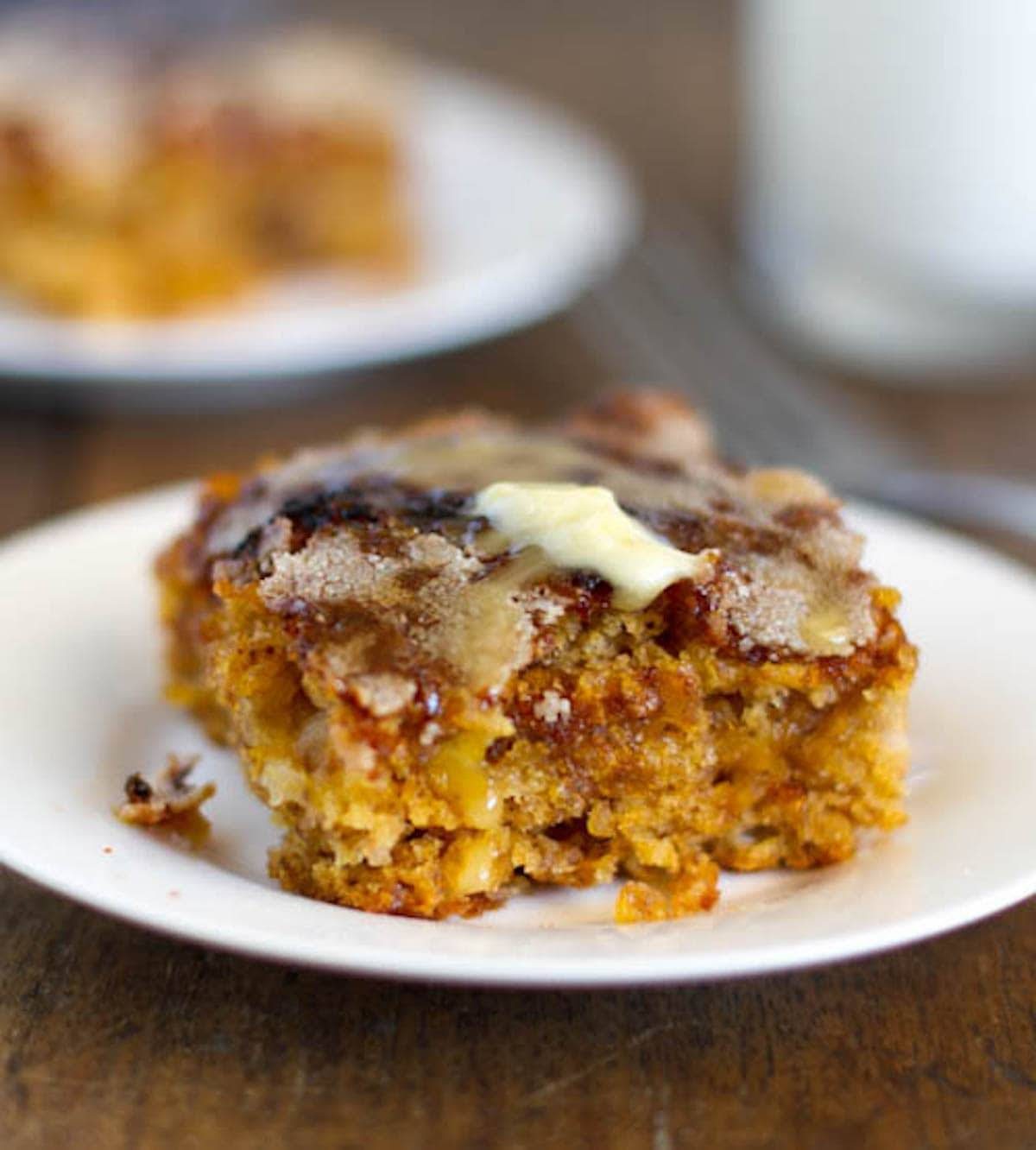 Mango snack cake with crunchy sugar topping on a white plate.