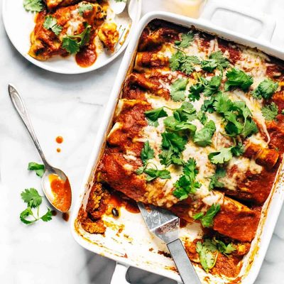 Quinoa Enchiladas in a pan with spatula.